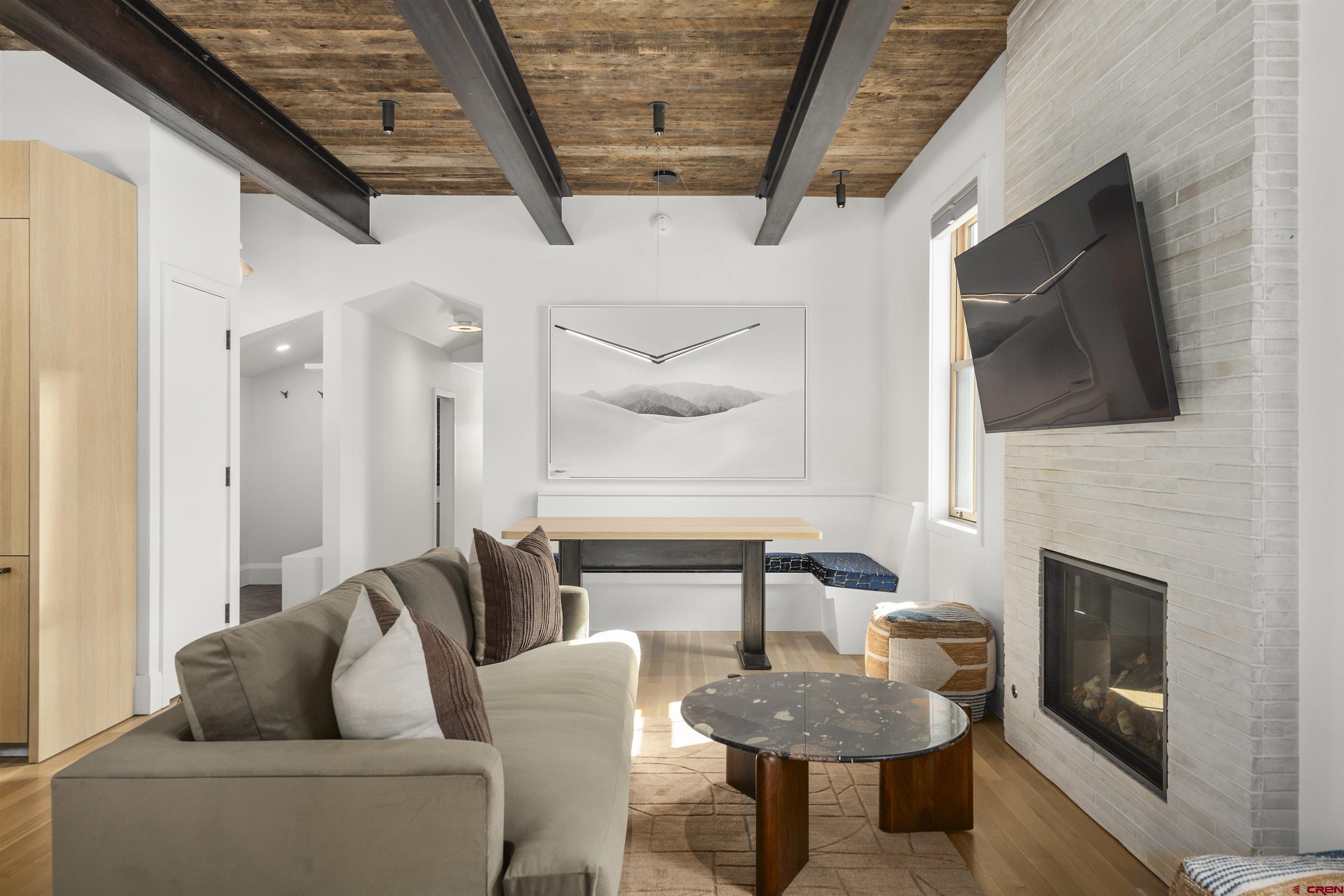 304 2nd Street Crested Butte, CO 81224 - Photo 3 of 37 a living room with furniture a flat screen tv and a fireplace