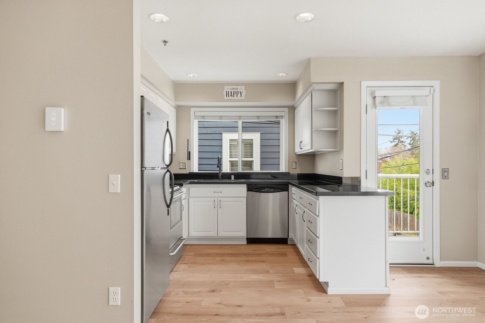 2116 California Avenue Southwest, Unit 201 Seattle, WA 98116 - Photo 11 of 33 a kitchen with stainless steel appliances granite countertop a stove a sink and a refrigerator