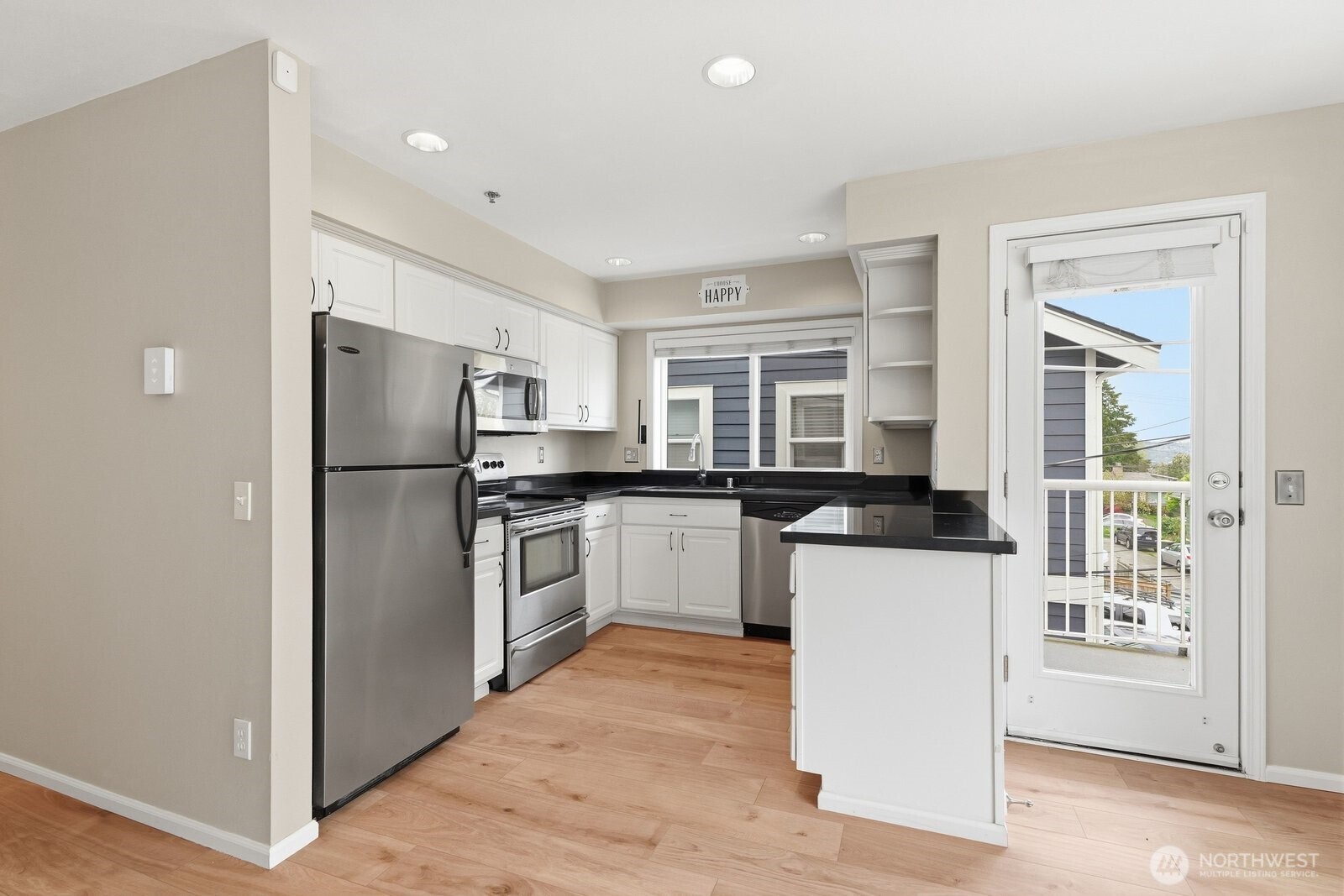 2116 California Avenue Southwest, Unit 201 Seattle, WA 98116 - Photo 12 of 33 a kitchen with a refrigerator a sink and a stove top oven