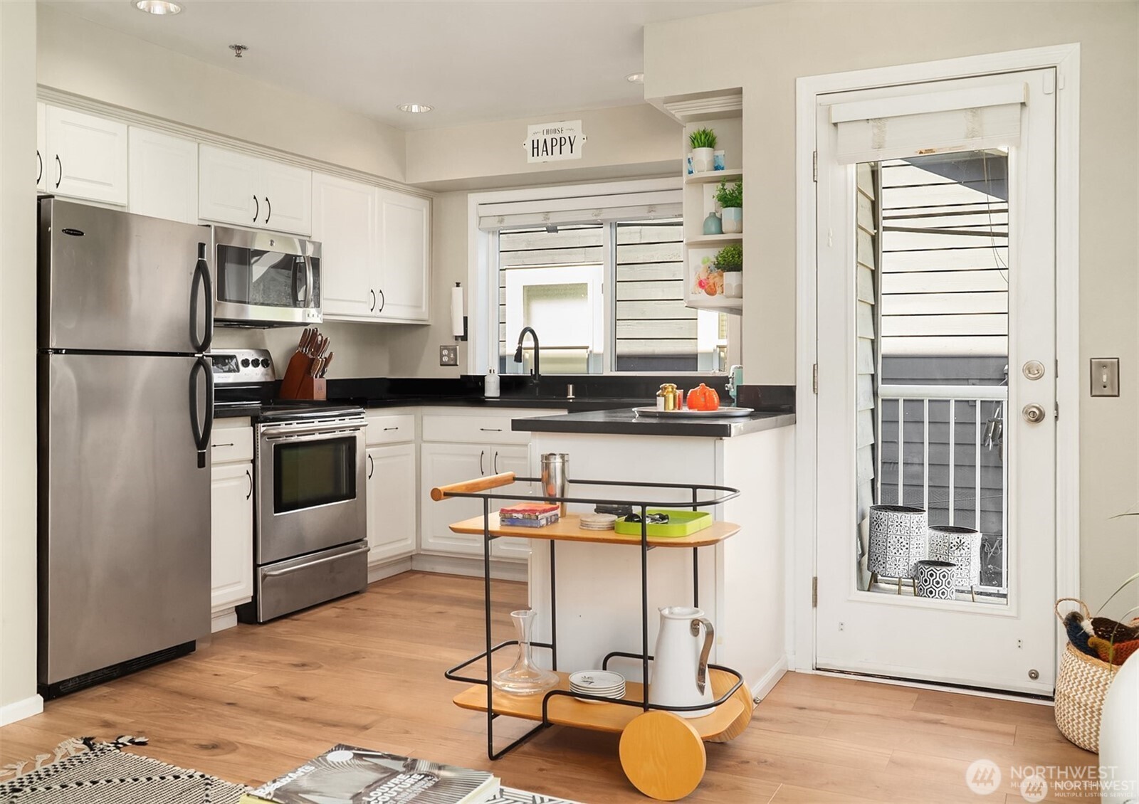 2116 California Avenue Southwest, Unit 201 Seattle, WA 98116 - Photo 13 of 33 a kitchen with stainless steel appliances granite countertop a stove a sink and a refrigerator