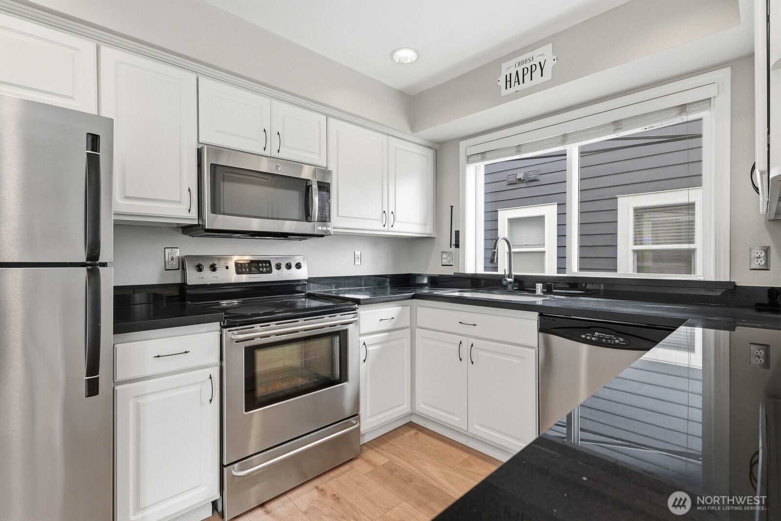 2116 California Avenue Southwest, Unit 201 Seattle, WA 98116 - Photo 16 of 33 a kitchen with stainless steel appliances granite countertop a stove microwave and refrigerator