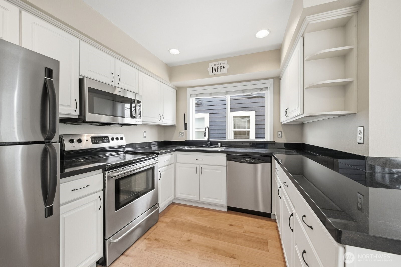 2116 California Avenue Southwest, Unit 201 Seattle, WA 98116 - Photo 18 of 33 a kitchen with granite countertop a sink stainless steel appliances and cabinets