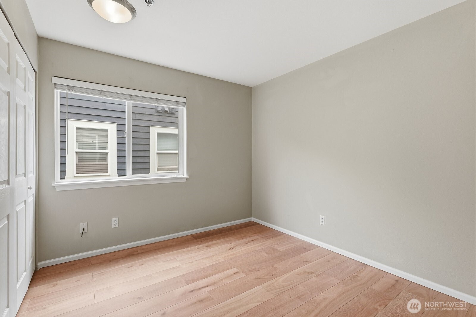 2116 California Avenue Southwest, Unit 201 Seattle, WA 98116 - Photo 19 of 33 a view of empty room with wooden floor and fan