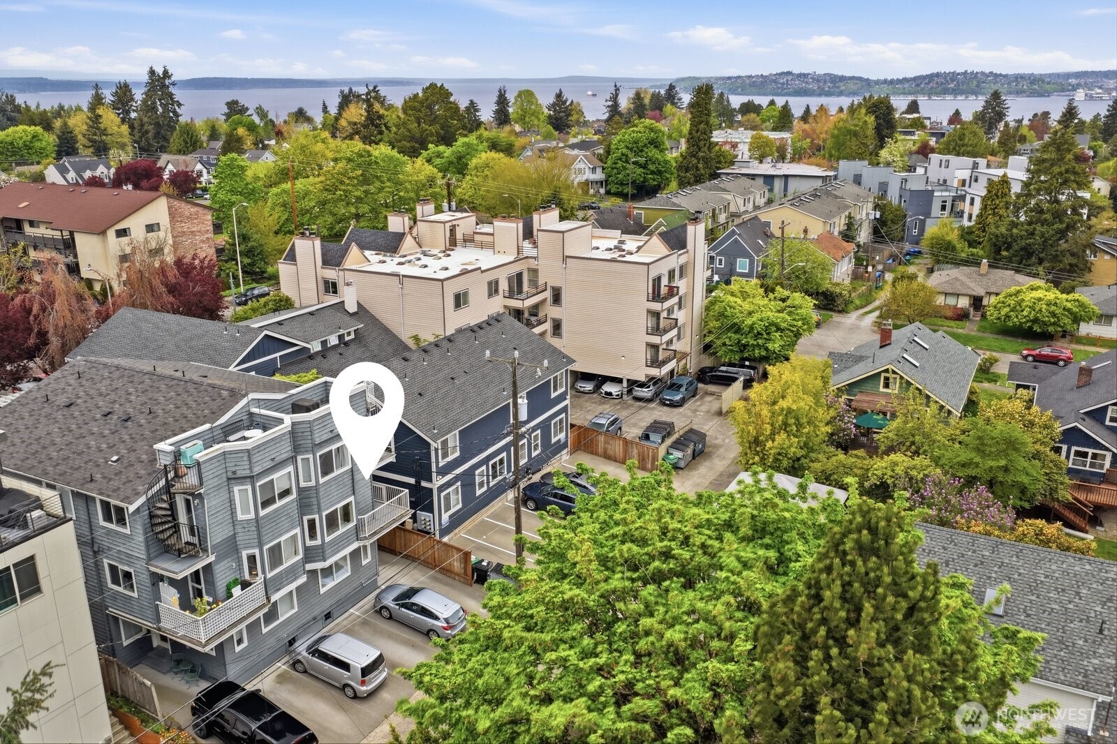 2116 California Avenue Southwest, Unit 201 Seattle, WA 98116 - Photo 2 of 33 an aerial view of a house with a yard and lake view