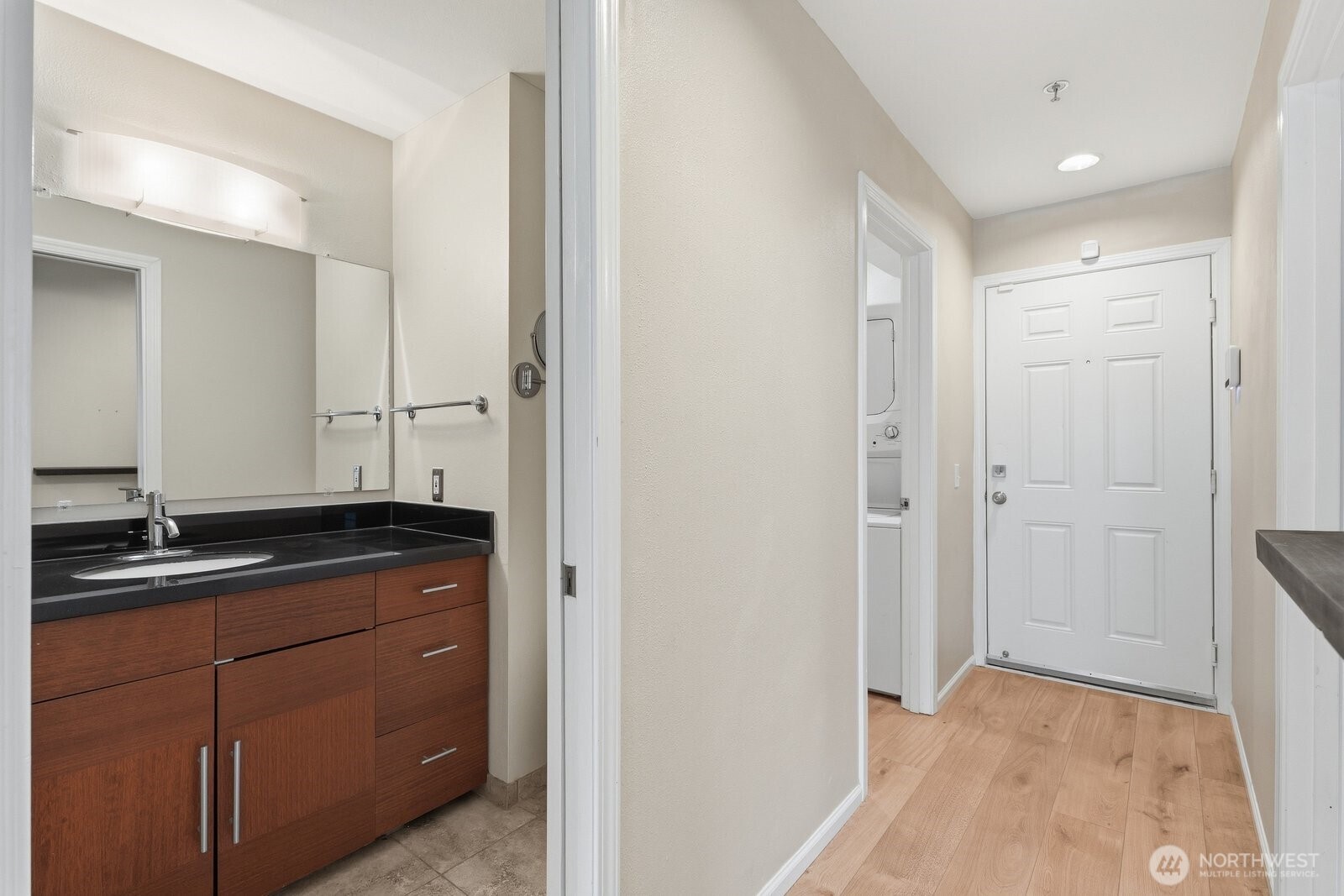 2116 California Avenue Southwest, Unit 201 Seattle, WA 98116 - Photo 23 of 33 a bathroom with a granite countertop sink and a mirror