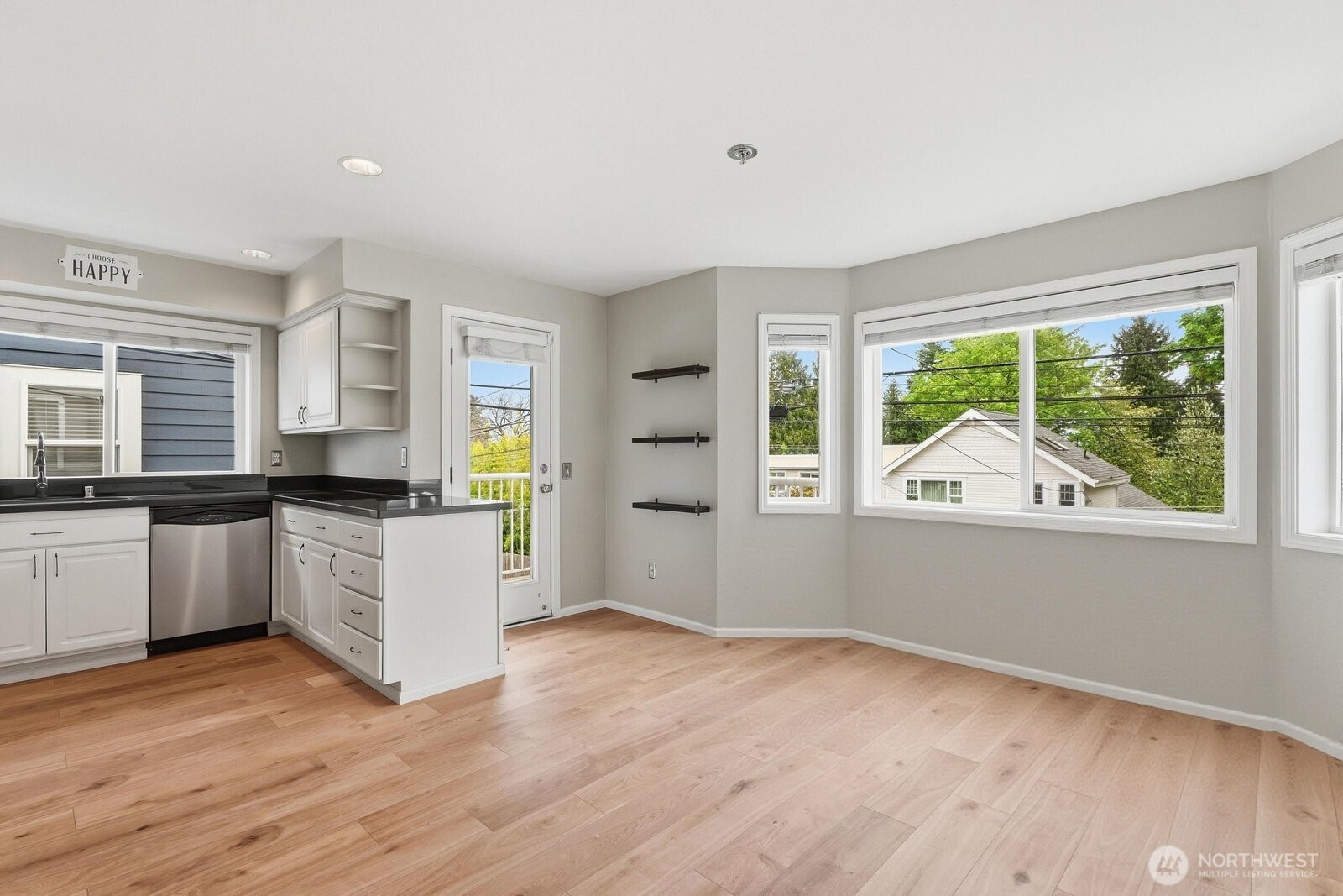 2116 California Avenue Southwest, Unit 201 Seattle, WA 98116 - Photo 5 of 33 a open kitchen with wooden floor and white appliances
