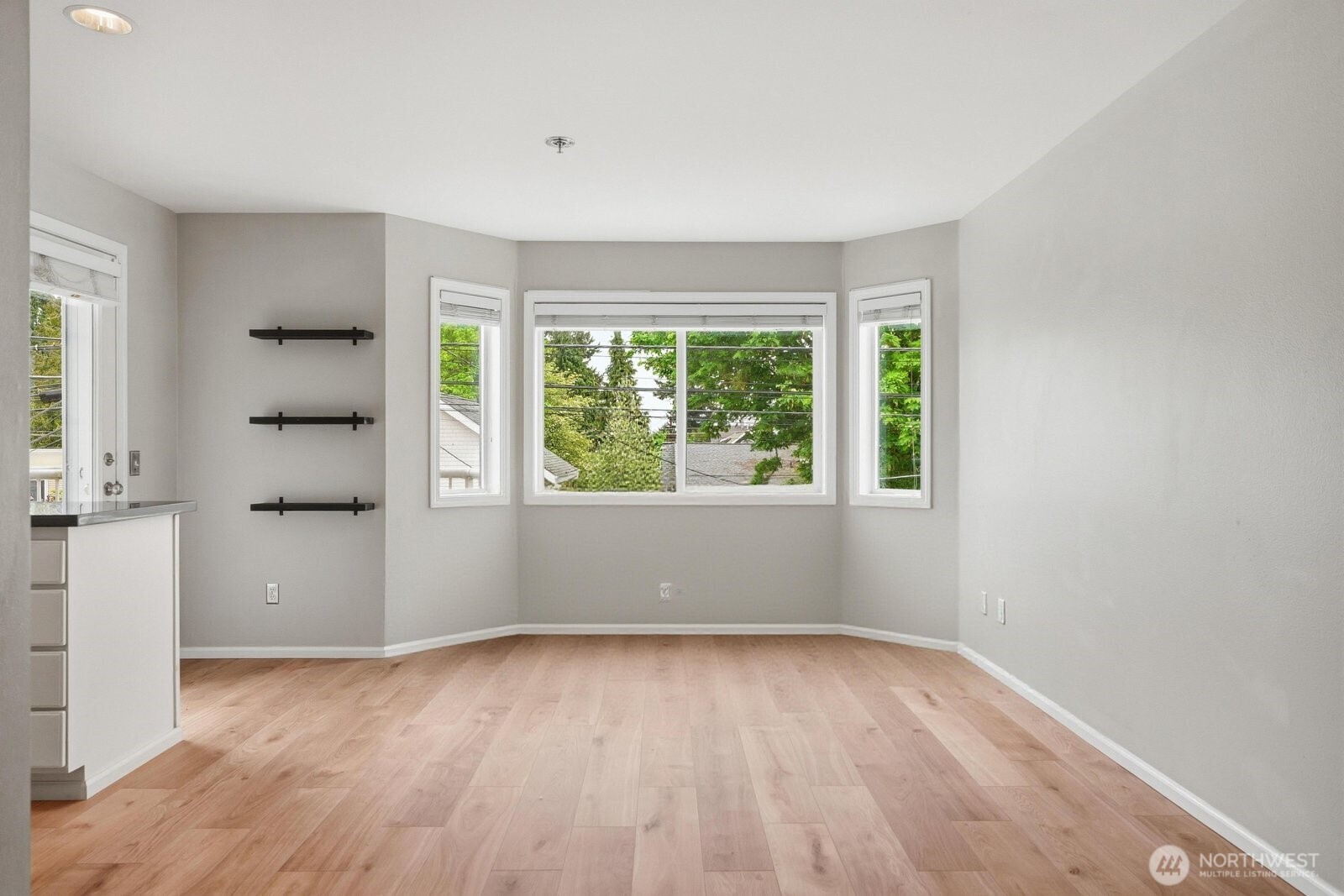 2116 California Avenue Southwest, Unit 201 Seattle, WA 98116 - Photo 9 of 33 wooden floor in an empty room with a window