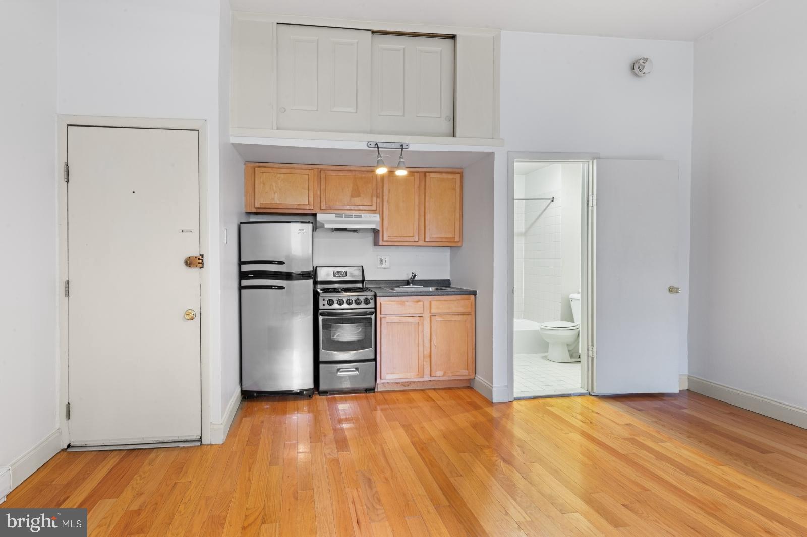 515 South 6th Street, Unit 1R Philadelphia, PA 19147 - Photo 2 of 17 a kitchen with stainless steel appliances a refrigerator and a stove top oven