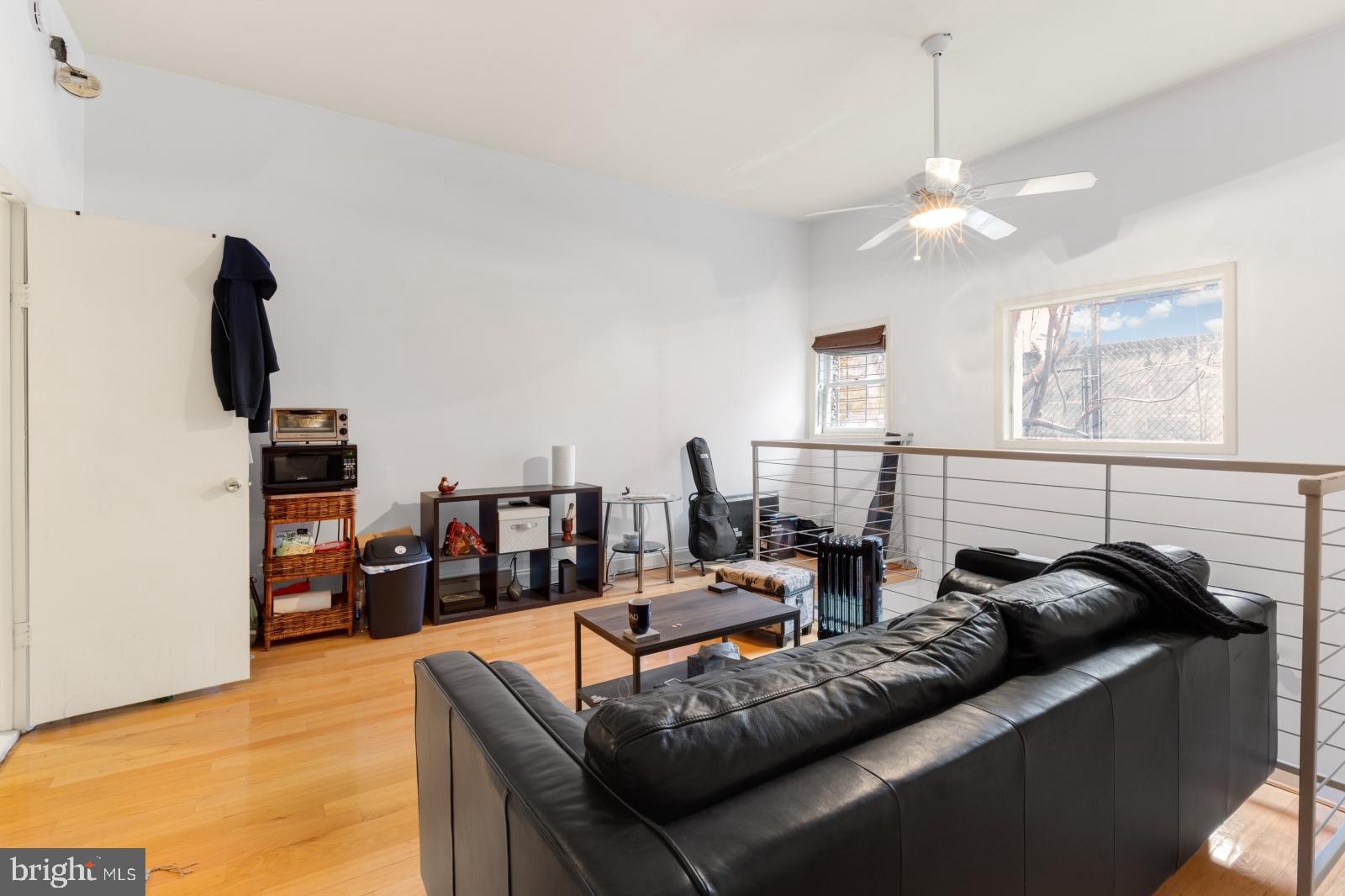 515 South 6th Street, Unit 1R Philadelphia, PA 19147 - Photo 4 of 17 a living room with furniture and a flat screen tv