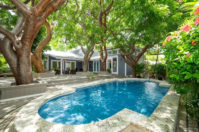 a view of a house with backyard porch and sitting area