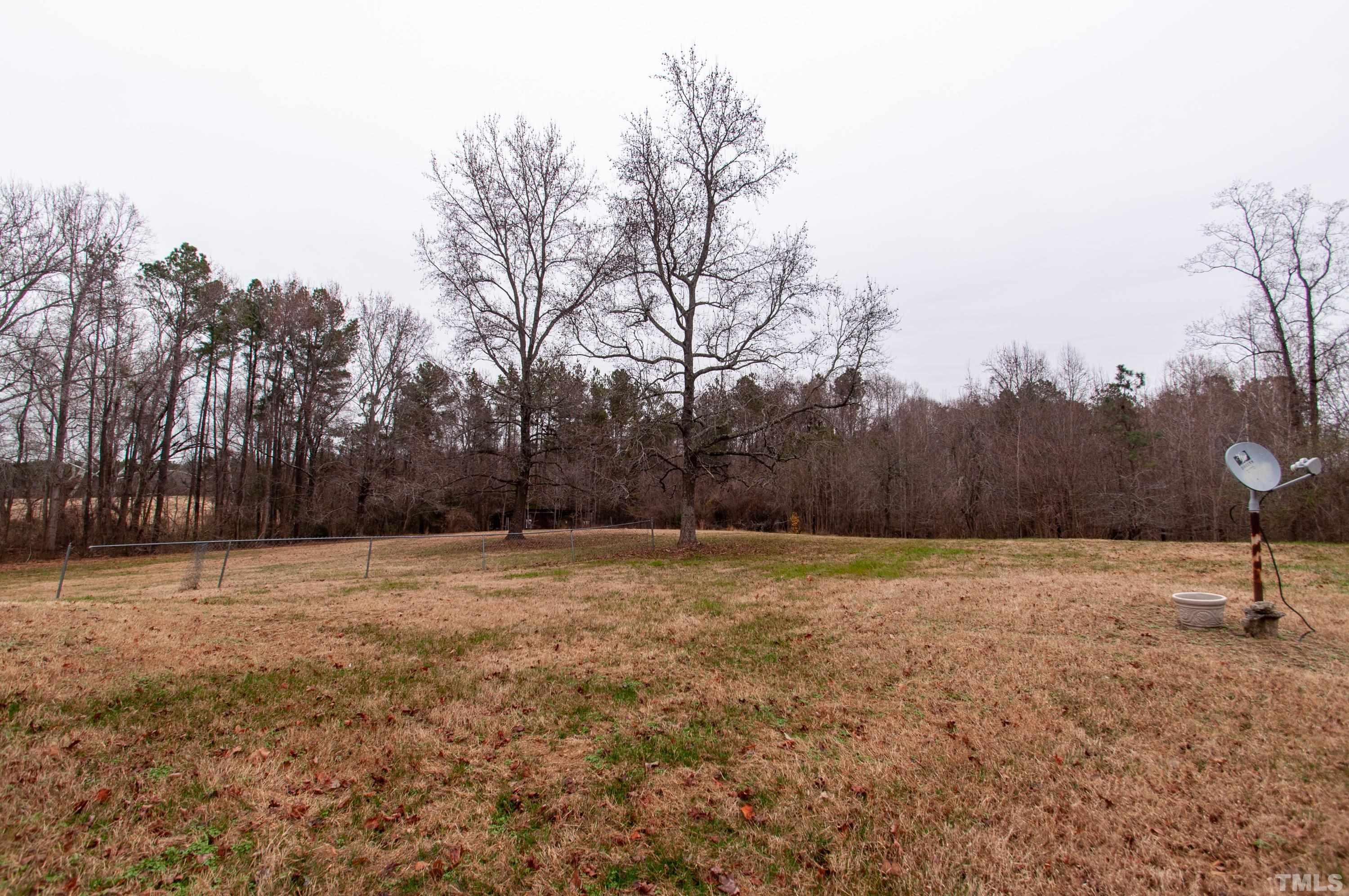 610 Flemingtown Road Henderson, NC 27537 - Photo 3 of 14 a backyard of a house with trees