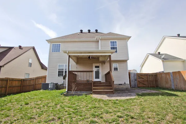 a view of a house with wooden fence