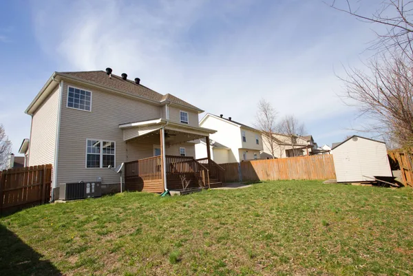 a view of a house with a yard and garage