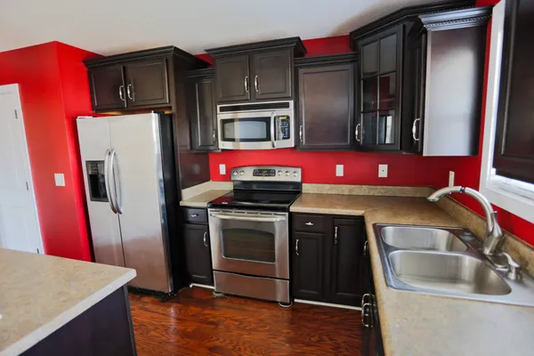 a kitchen with stainless steel appliances a refrigerator a stove and a sink