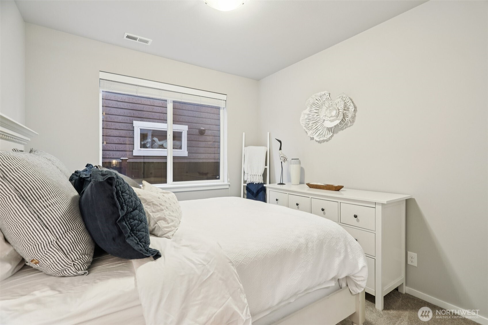 18533 115th Place Southeast Renton, WA 98055 - Photo 13 of 30 a bed sitting in a bedroom next to a window and a dresser
