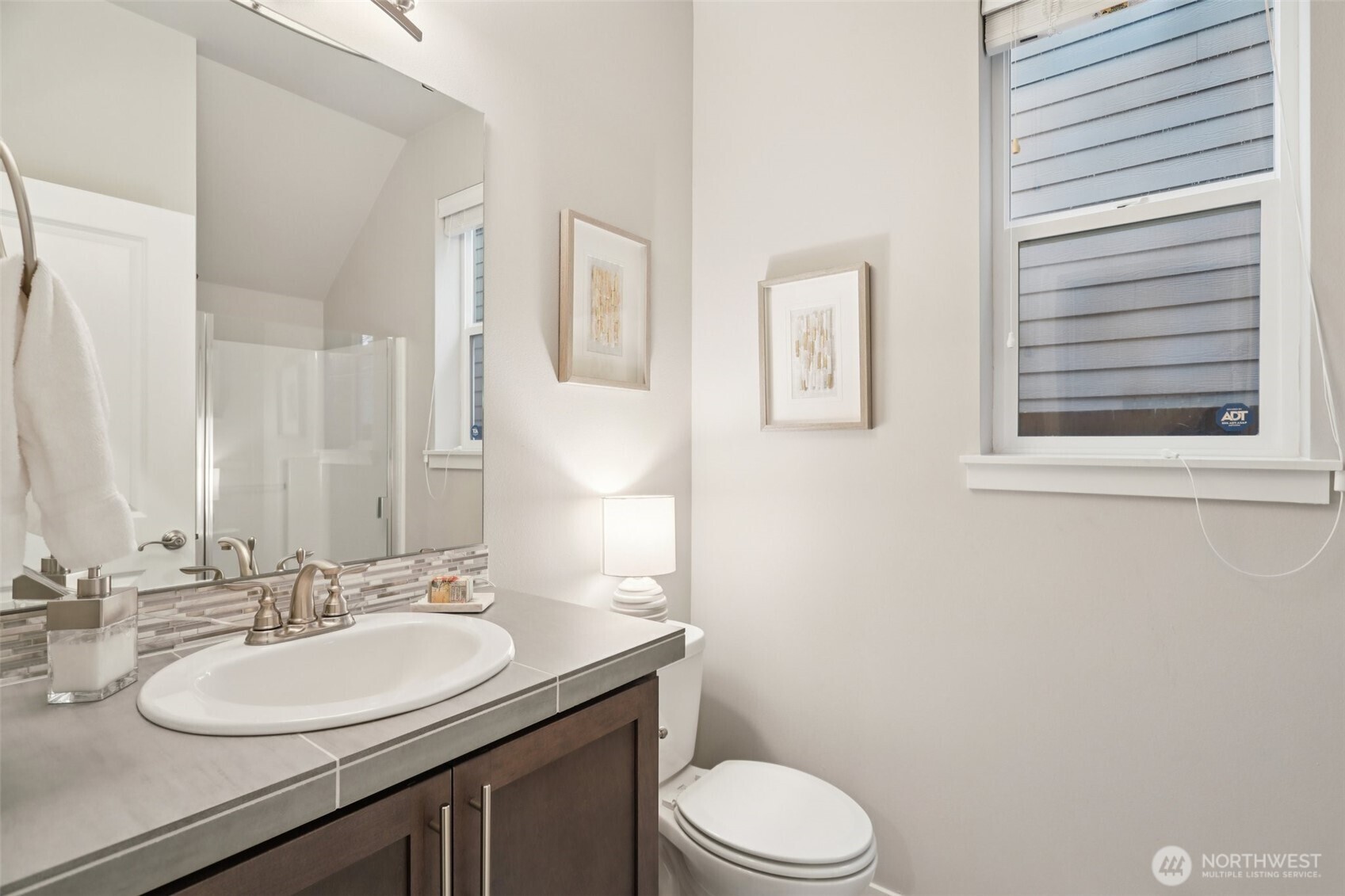 18533 115th Place Southeast Renton, WA 98055 - Photo 15 of 30 a bathroom with a granite countertop toilet sink and mirror