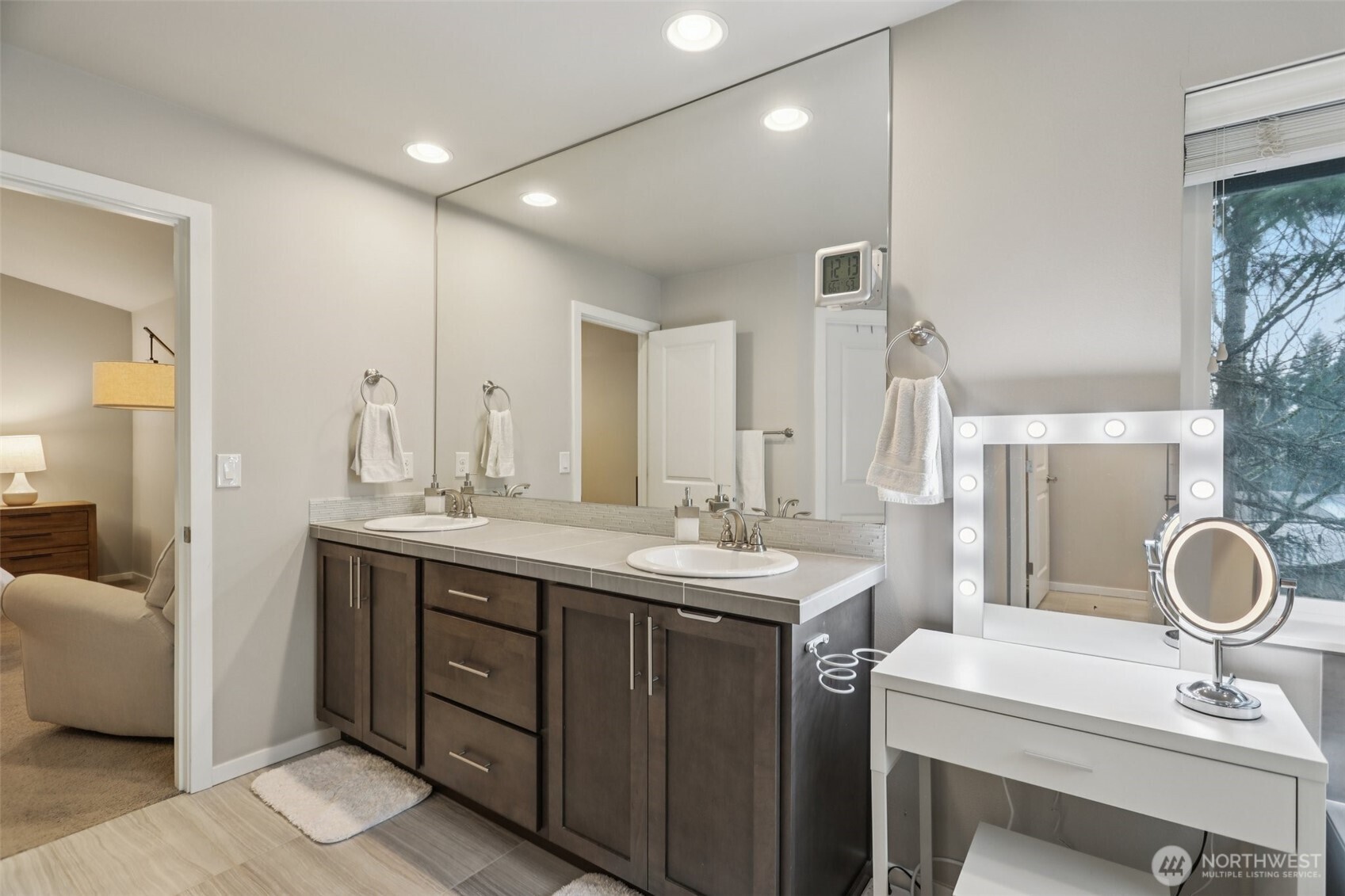 18533 115th Place Southeast Renton, WA 98055 - Photo 19 of 30 a bathroom with a double vanity sink a mirror and a shower