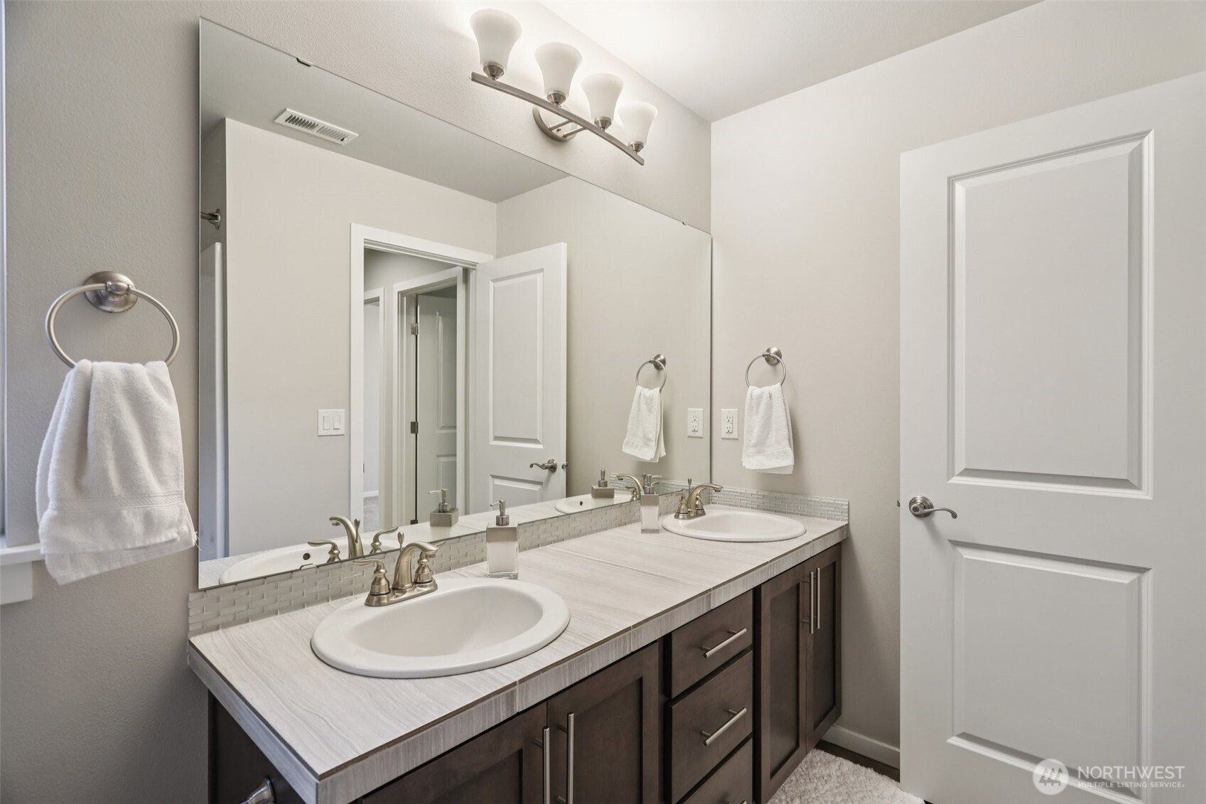 18533 115th Place Southeast Renton, WA 98055 - Photo 23 of 30 a bathroom with a sink double vanity and a mirror