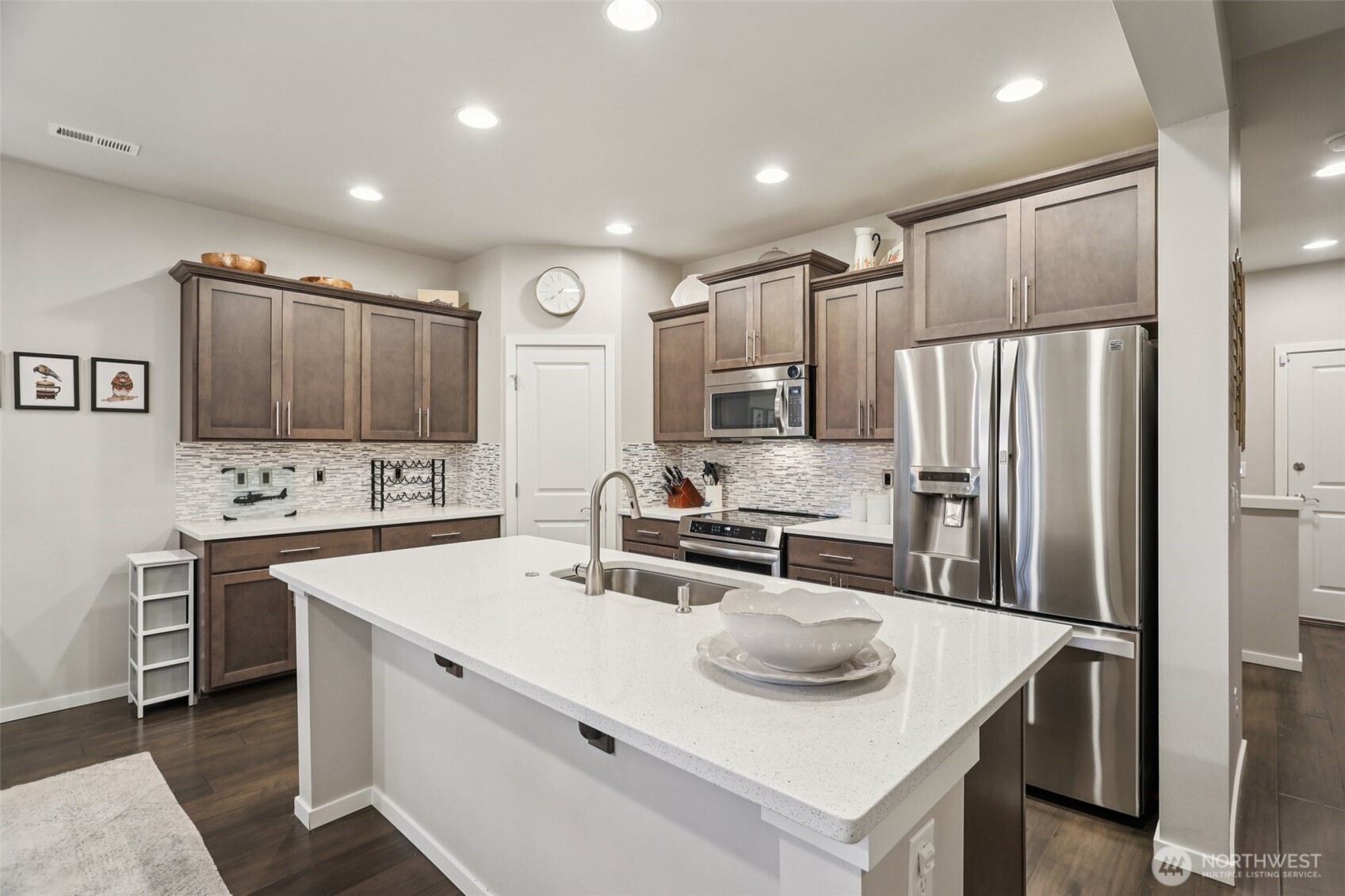 18533 115th Place Southeast Renton, WA 98055 - Photo 8 of 30 a kitchen with stainless steel appliances a stove refrigerator sink and microwave