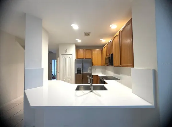 a large white kitchen with a sink and dishwasher