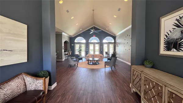 a dining room with furniture a chandelier and wooden floor