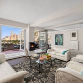 a living room with furniture and a book shelf