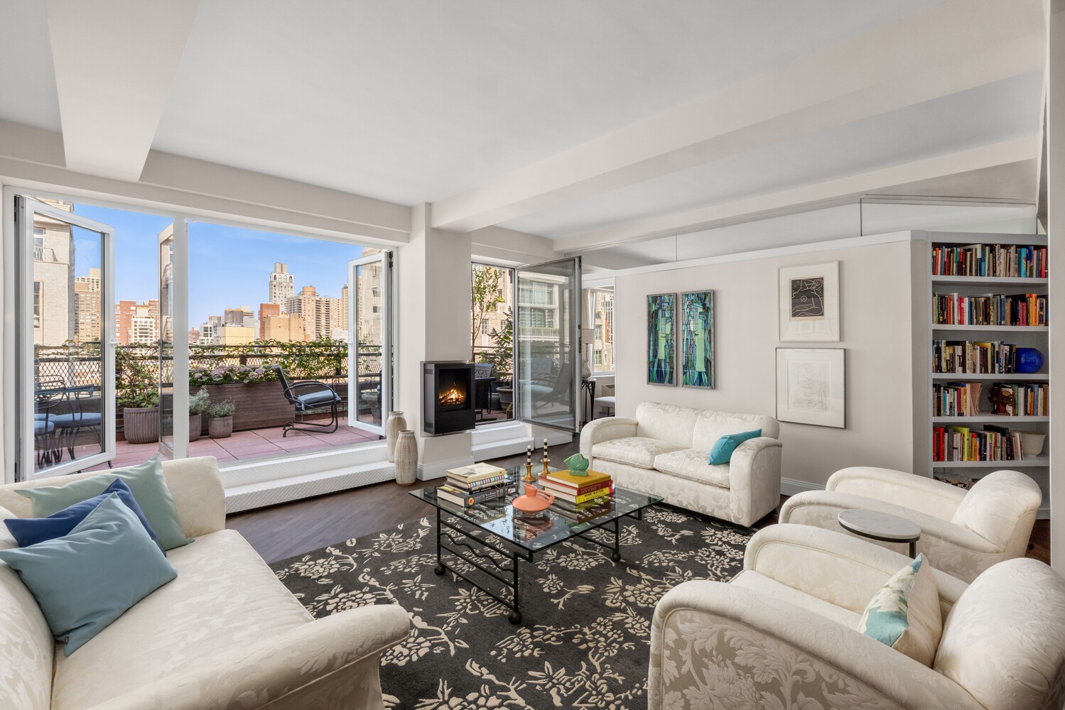 a living room with furniture and a book shelf