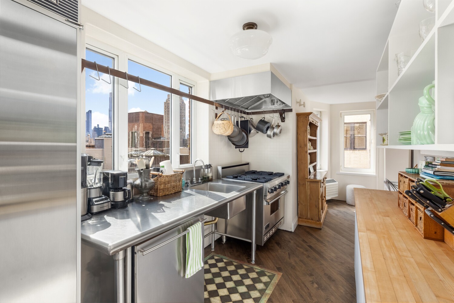 120 East 79th Street, Unit PH20 Manhattan, NY 10075 - Photo 14 of 20 a kitchen with stainless steel appliances granite countertop a stove and a view of living room