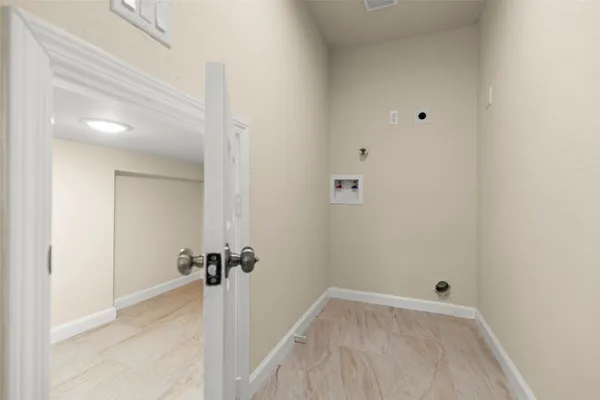 a view of a room with wooden floor