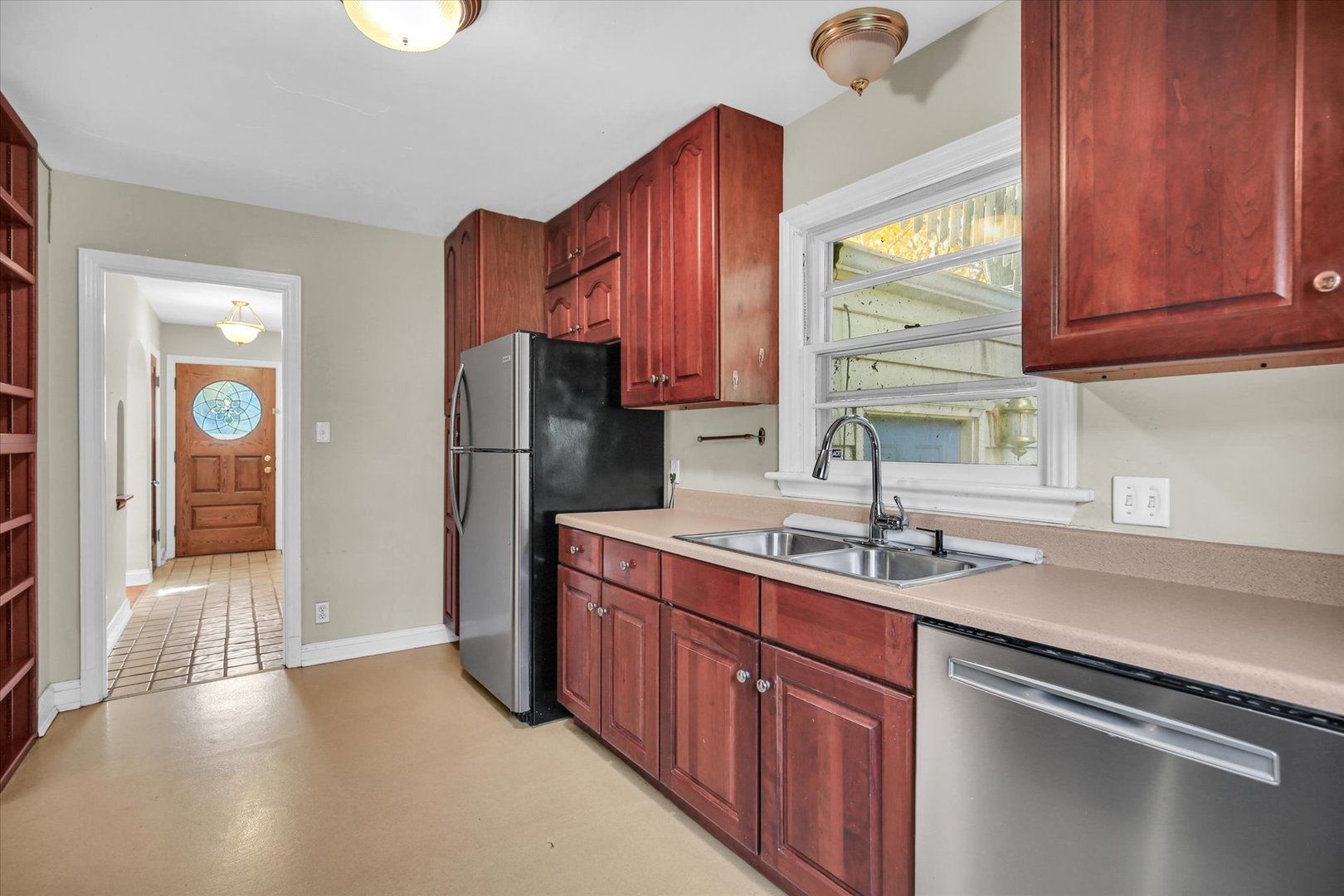 910 West Springfield Avenue Champaign, IL 61821 - Photo 14 of 45 a kitchen with stainless steel appliances granite countertop a refrigerator and a sink