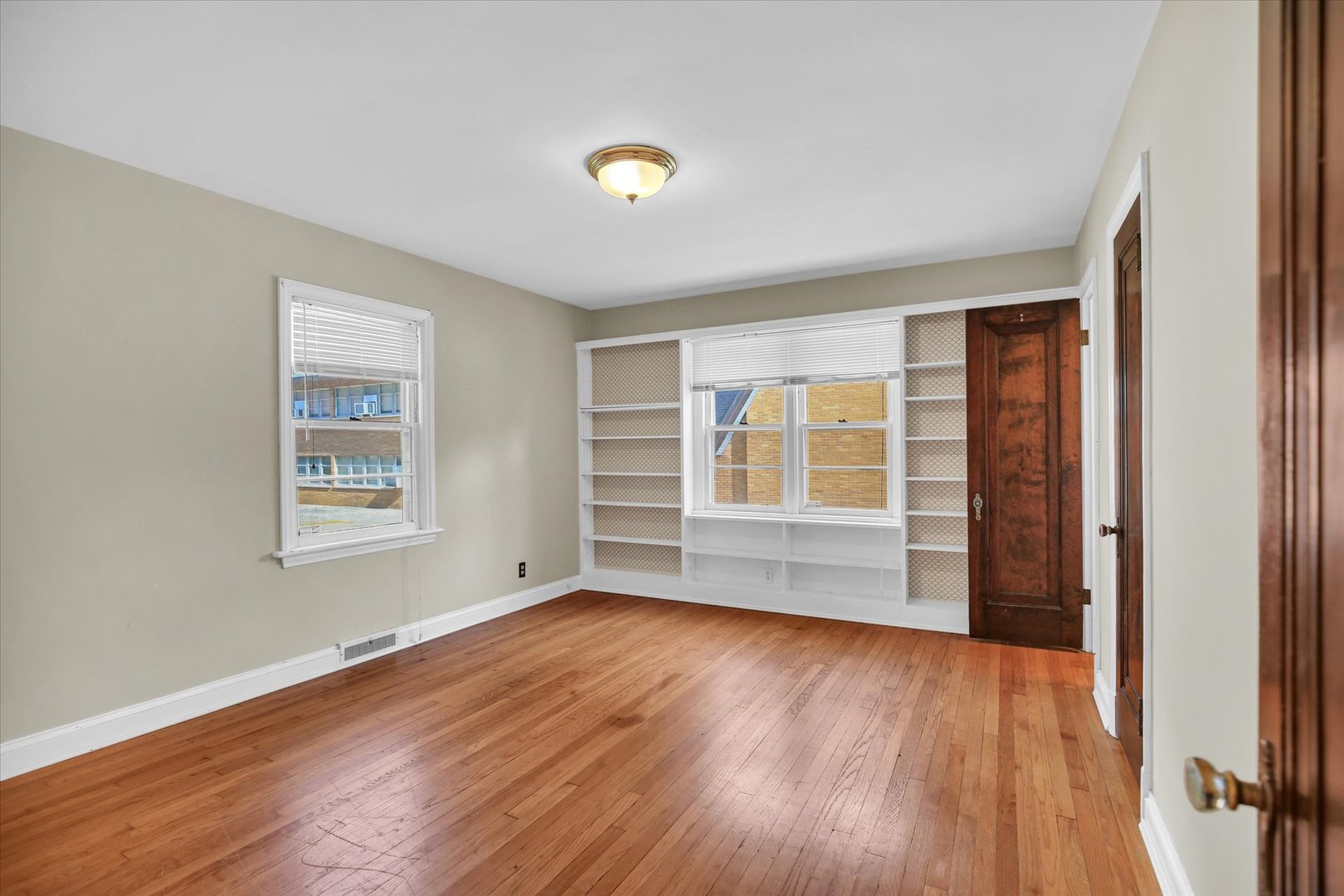 910 West Springfield Avenue Champaign, IL 61821 - Photo 18 of 45 a view of an empty room with wooden floor and a window