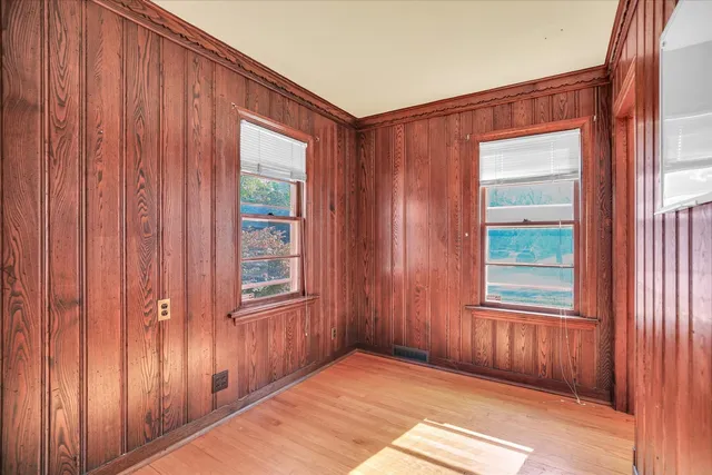 a view of empty room with wooden floor