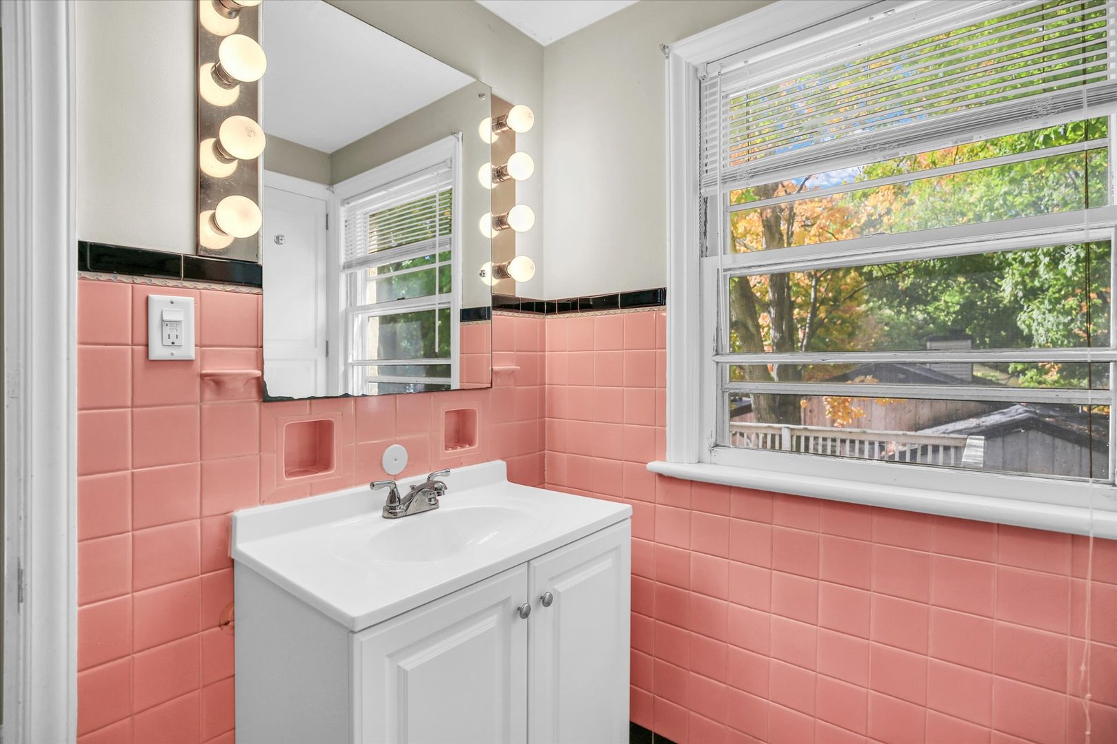 910 West Springfield Avenue Champaign, IL 61821 - Photo 30 of 45 a bathroom with a sink and a large mirror