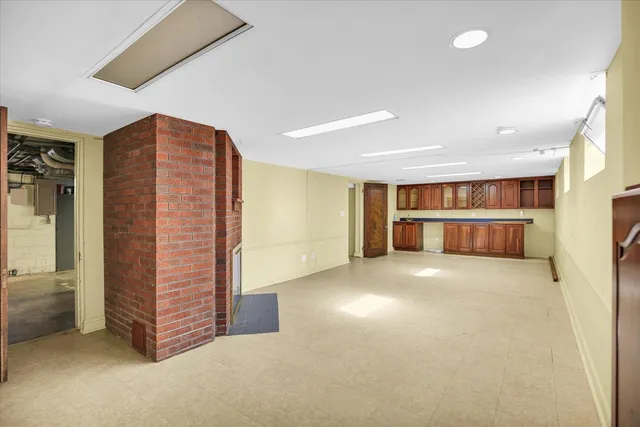 an empty room with furniture and a fireplace