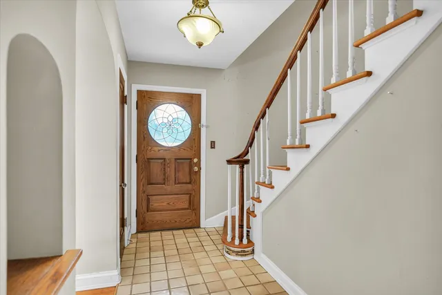 a view of a hallway with entryway wooden floor and front door