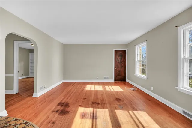 wooden floor in a room next to a window