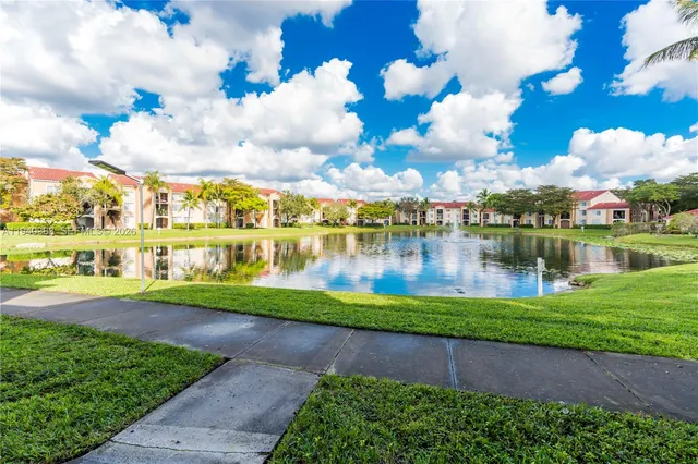 a view of a lake with houses in the back