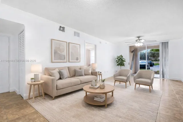 a living room with furniture and a large window