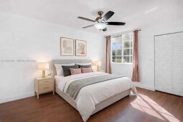 a bedroom with a large bed and a ceiling fan