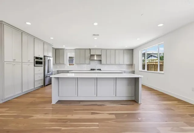 a kitchen with kitchen island white cabinets appliances and cabinets
