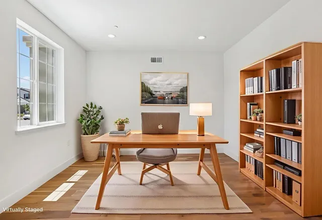 a white bath tub sitting next to a shower