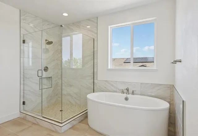a bathroom with double vanity sinks and a mirror