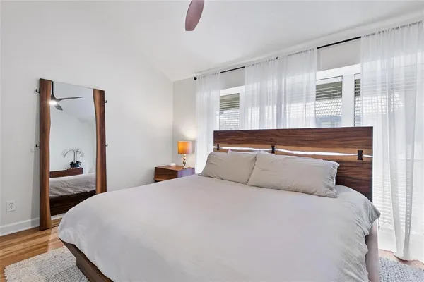 a bedroom with a bed and a large mirror