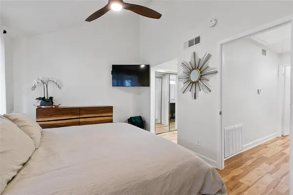 a bedroom with a bed and a flat screen tv