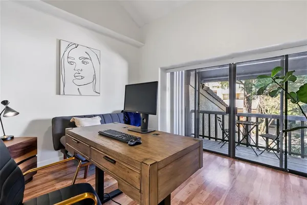 a view of a workspace with furniture and a potted plant