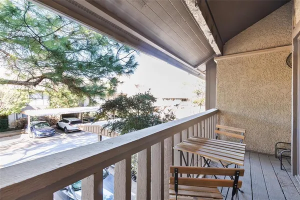 a view of a balcony with wooden floor