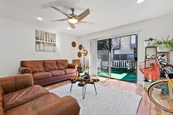 a living room with furniture a rug and a large window