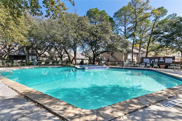 a view of a house with swimming pool and a yard