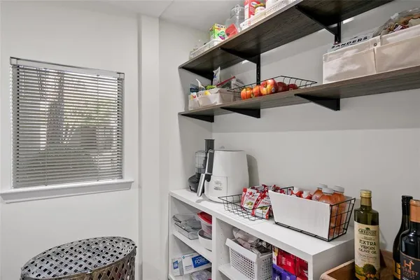 a kitchen with a white cabinets and window