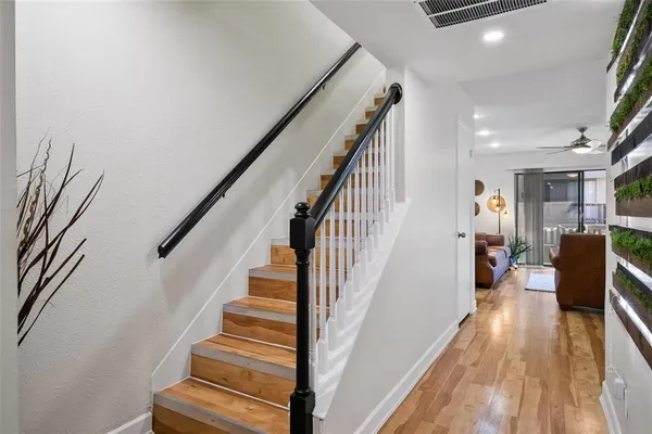 a view of entryway and hall with wooden floor